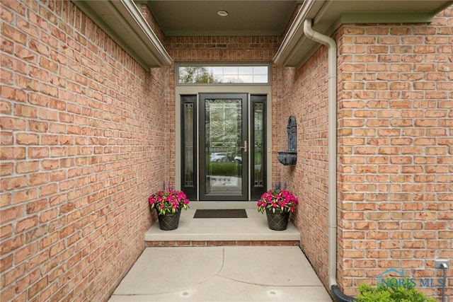 property entrance with brick siding