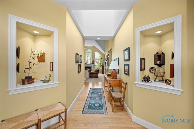 hall with recessed lighting, baseboards, and wood finished floors