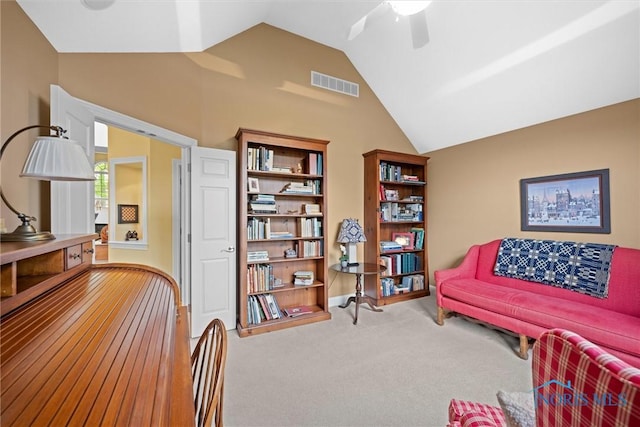 sitting room with lofted ceiling, a ceiling fan, visible vents, and carpet floors