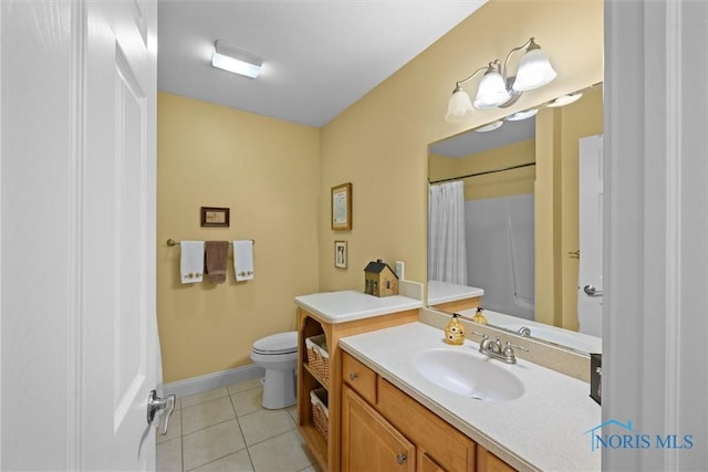 bathroom with toilet, a shower with curtain, baseboards, tile patterned flooring, and vanity