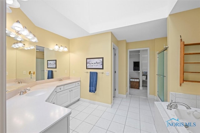 bathroom with a stall shower, a bath, a sink, tile patterned floors, and double vanity