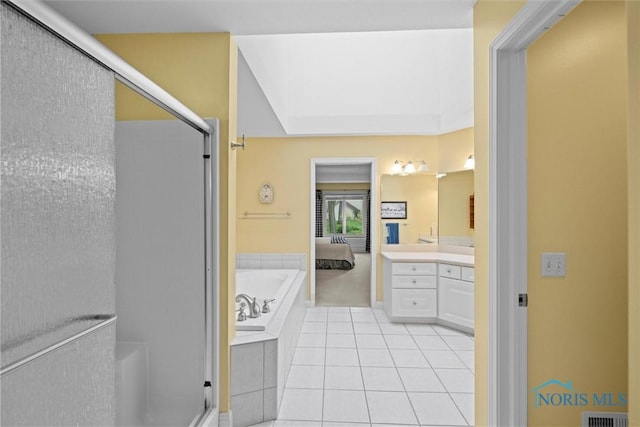 full bathroom featuring a stall shower, vanity, a garden tub, and tile patterned floors