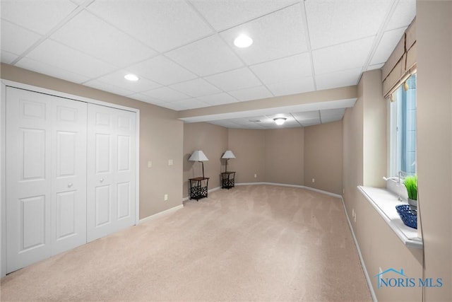 below grade area featuring recessed lighting, a paneled ceiling, baseboards, and carpet floors