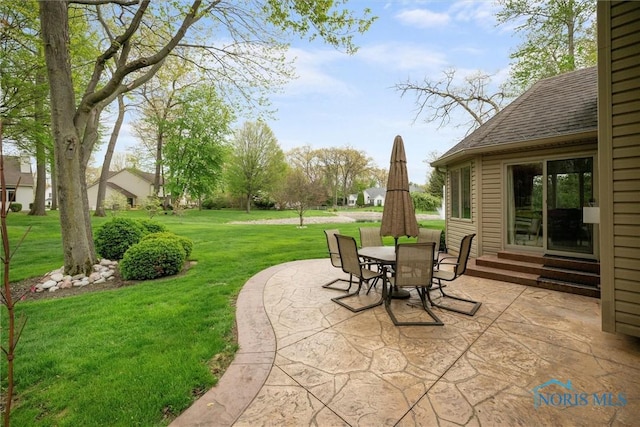 view of patio featuring entry steps and outdoor dining area