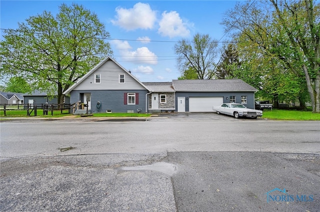 view of front of property featuring aphalt driveway and an attached garage