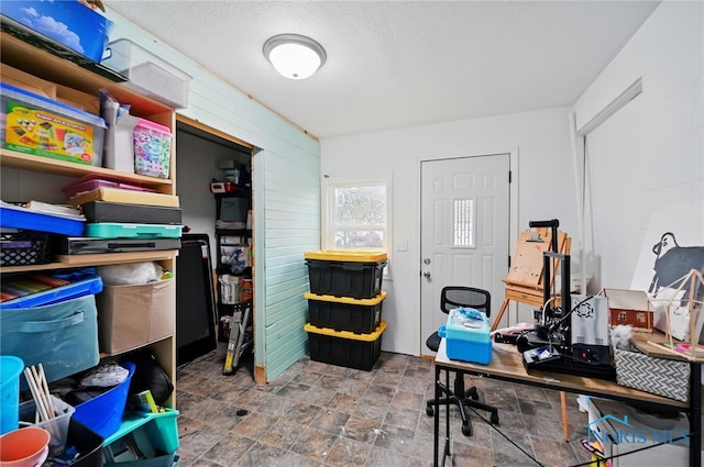 office space featuring stone finish flooring and a textured ceiling