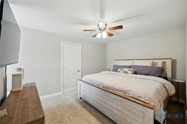 carpeted bedroom with baseboards and a ceiling fan