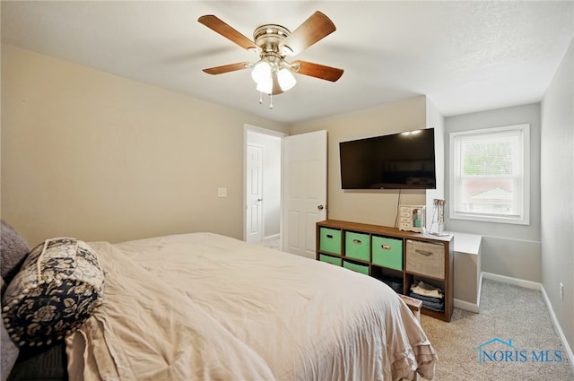 bedroom featuring light carpet, baseboards, and a ceiling fan