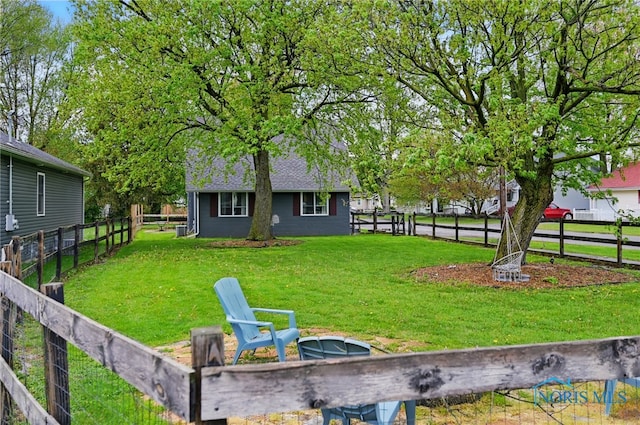 view of yard with a fire pit and a fenced backyard