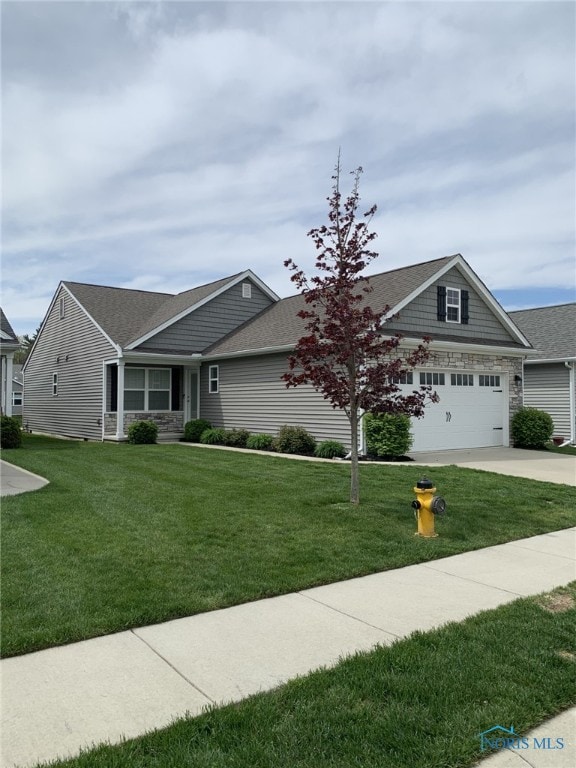 view of front of property featuring concrete driveway, a shingled roof, and a front yard