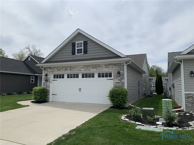 exterior space with stone siding, a garage, driveway, and a front yard