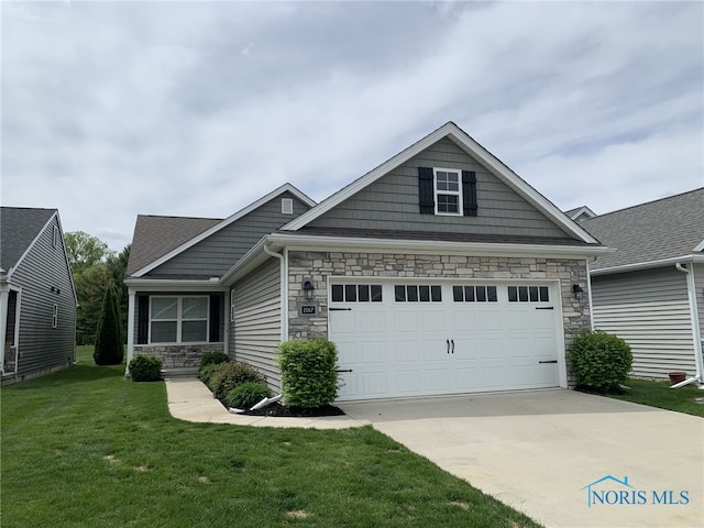 craftsman house with stone siding, a front yard, driveway, and a garage