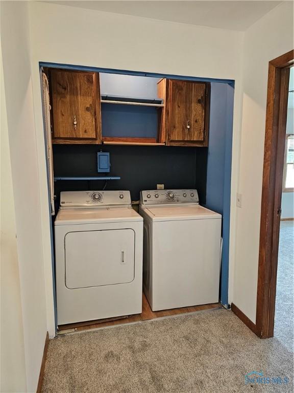 23675 W State Route 51, Genoa, OH 43430 - laundry room with cabinet space, washer and dryer, light carpet, and baseboards