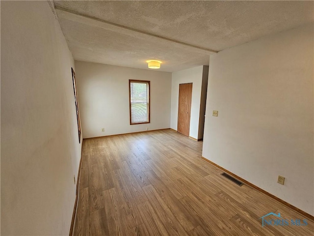 23675 W State Route 51, Genoa, OH 43430 - spare room with light wood finished floors, a textured ceiling, and baseboards