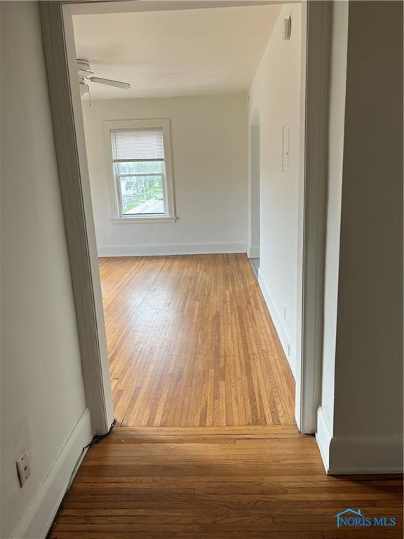2289 Upton Ave, Toledo, OH 43606 - hallway with wood finished floors, arched walkways, and baseboards