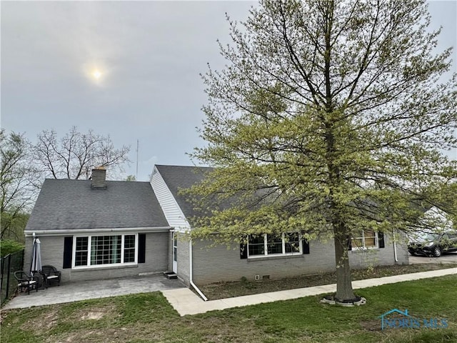 12982 State Route 34, Bryan, OH 43506 - view of front of house with a patio, brick siding, a chimney, and a shingled roof