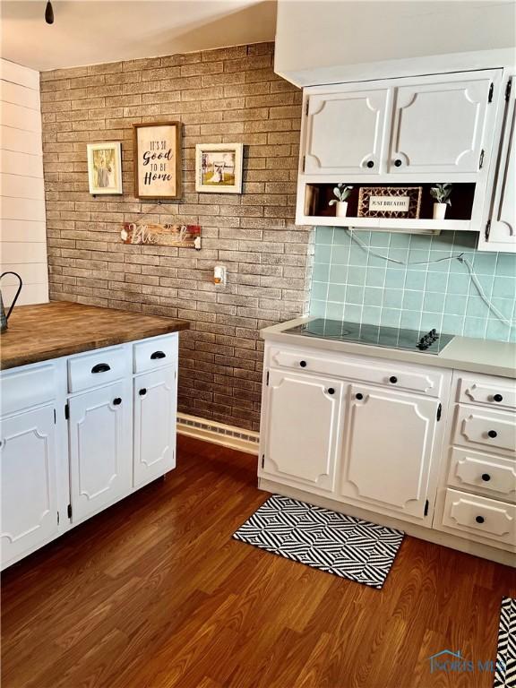 12982 State Route 34, Bryan, OH 43506 - kitchen with open shelves, white cabinets, butcher block counters, brick wall, and dark wood-type flooring