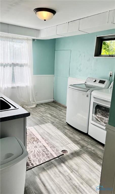 12982 State Route 34, Bryan, OH 43506 - washroom with washing machine and clothes dryer and light wood-style flooring