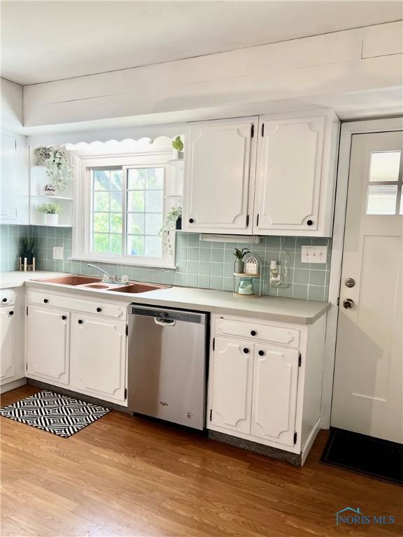 12982 State Route 34, Bryan, OH 43506 - kitchen featuring dishwasher, white cabinets, dark wood-type flooring, and backsplash