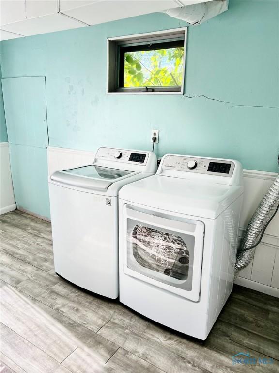 12982 State Route 34, Bryan, OH 43506 - laundry area featuring washing machine and dryer and light wood-type flooring