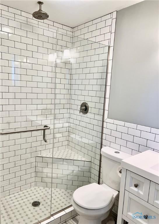 12982 State Route 34, Bryan, OH 43506 - full bathroom with tile walls, a stall shower, toilet, and vanity