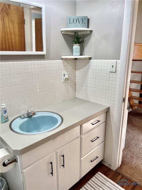12982 State Route 34, Bryan, OH 43506 - bathroom with tile walls, vanity, and tasteful backsplash