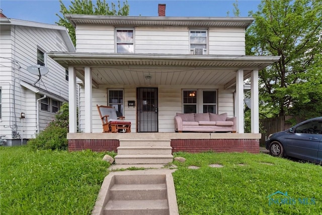 119 Carbon St, Toledo, OH 43605 - american foursquare style home featuring covered porch, a chimney, and fence