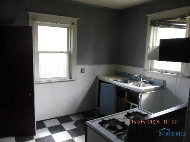 kitchen with a sink, plenty of natural light, and tile patterned floors