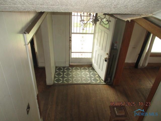 doorway with a notable chandelier and wood finished floors