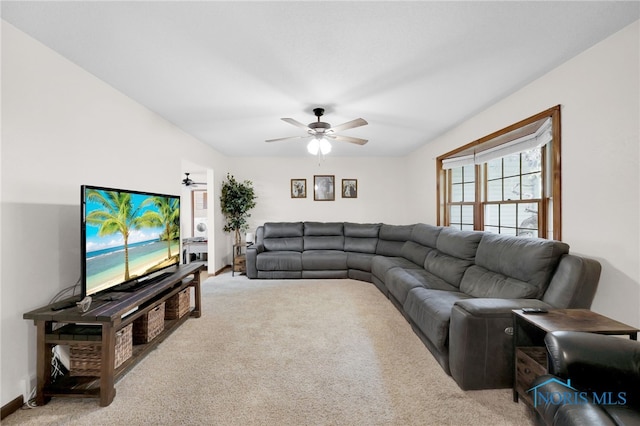 carpeted living area with ceiling fan