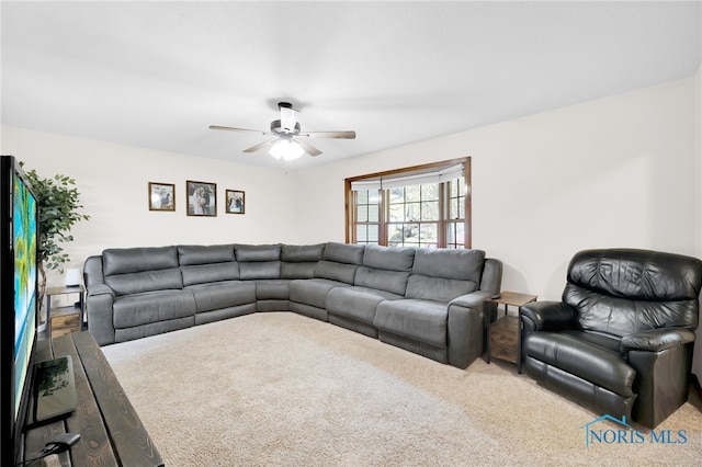 carpeted living area with ceiling fan