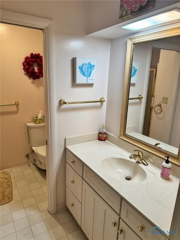 1006 Fairlawn Dr, Bryan, OH 43506 - bathroom featuring tile patterned floors, toilet, vanity, and baseboards