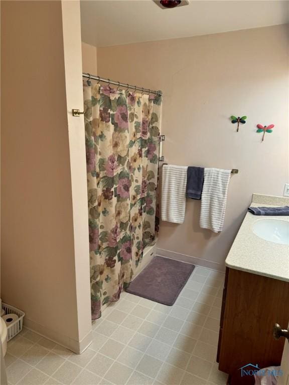 1006 Fairlawn Dr, Bryan, OH 43506 - bathroom with a shower with shower curtain, vanity, and baseboards