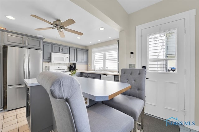 dining area with a ceiling fan and recessed lighting