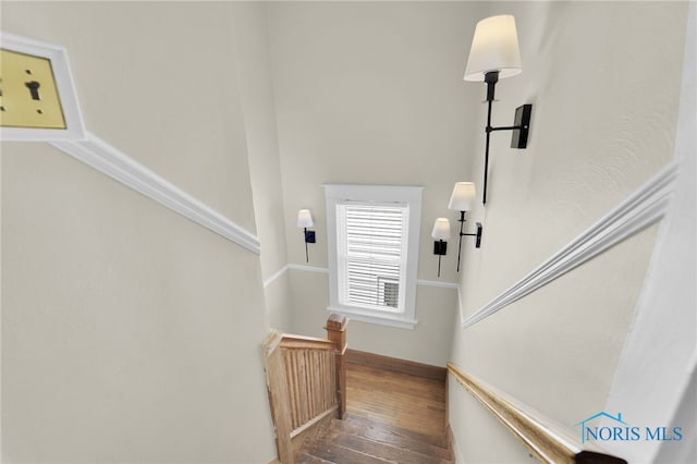 stairs featuring wood-type flooring and baseboards