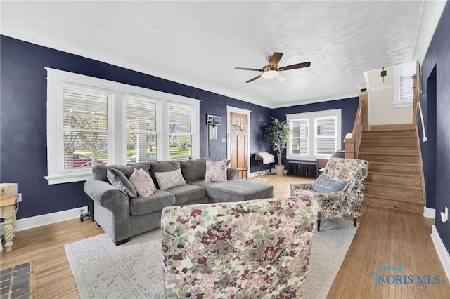 living room featuring wood finished floors, radiator heating unit, stairway, a ceiling fan, and baseboards