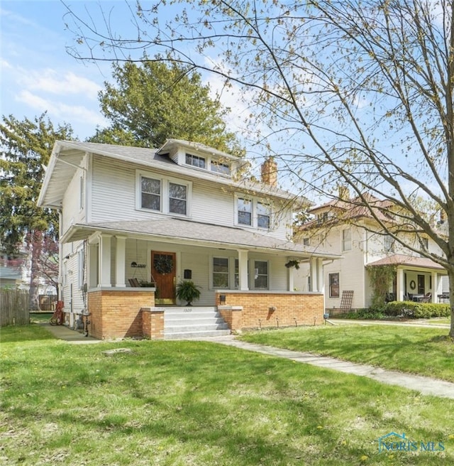 traditional style home with covered porch and brick siding