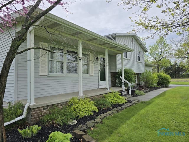 view of side of home featuring a yard