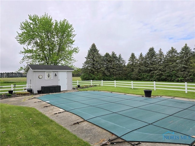 view of pool with a yard, an outbuilding, a fenced in pool, fence, and a shed