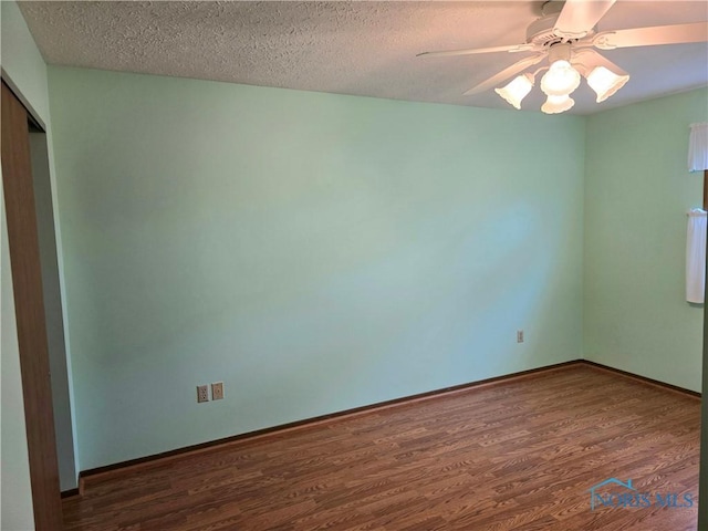 13941 Hannah Rd, Bowling Green, OH 43402 - empty room with wood finished floors, a ceiling fan, baseboards, and a textured ceiling