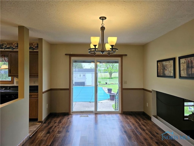 13941 Hannah Rd, Bowling Green, OH 43402 - entryway with a chandelier, dark wood-style floors, a textured ceiling, and baseboards