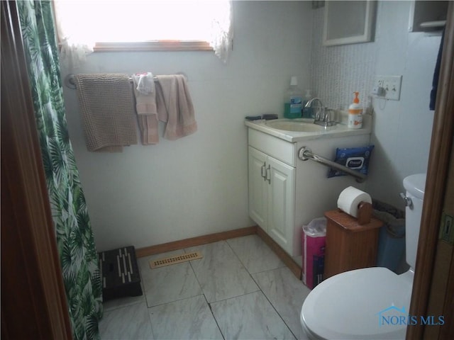 1390 Ayersville Ave, Defiance, OH 43512 - full bath with vanity, toilet, marble finish floor, and visible vents
