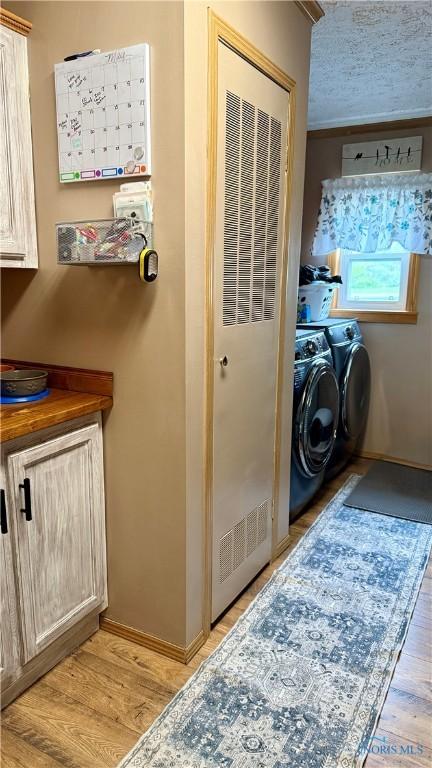 17262 US Route 127, Cecil, OH 45821 - laundry room with washing machine and dryer, light wood finished floors, and a heating unit
