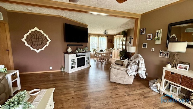 17262 US Route 127, Cecil, OH 45821 - living room with a textured ceiling, wood finished floors, ornamental molding, a ceiling fan, and baseboards