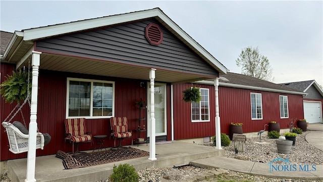 17262 US Route 127, Cecil, OH 45821 - view of front of house featuring a porch, an attached garage, and driveway