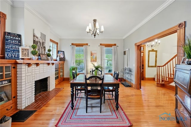 dining space featuring a chandelier, wood finished floors, and stairway
