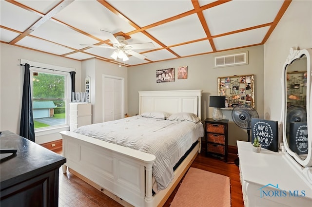 bedroom with dark wood-style flooring, ceiling fan, and visible vents