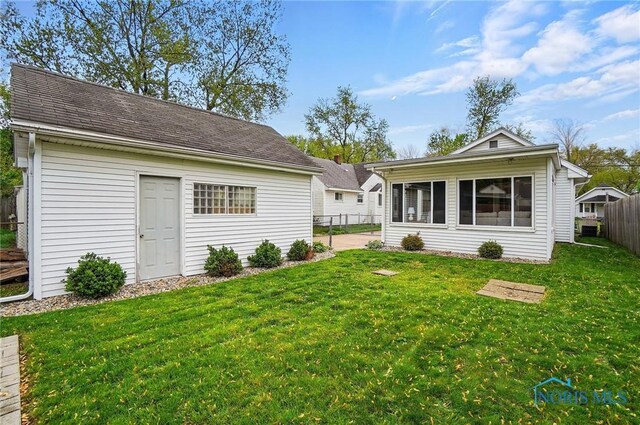 5036 Trellis Way, Sylvania, OH 43560 - rear view of property with a sunroom and an outbuilding