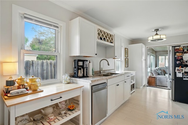 5036 Trellis Way, Sylvania, OH 43560 - kitchen with appliances with stainless steel finishes, a sink, light countertops, white cabinets, and crown molding