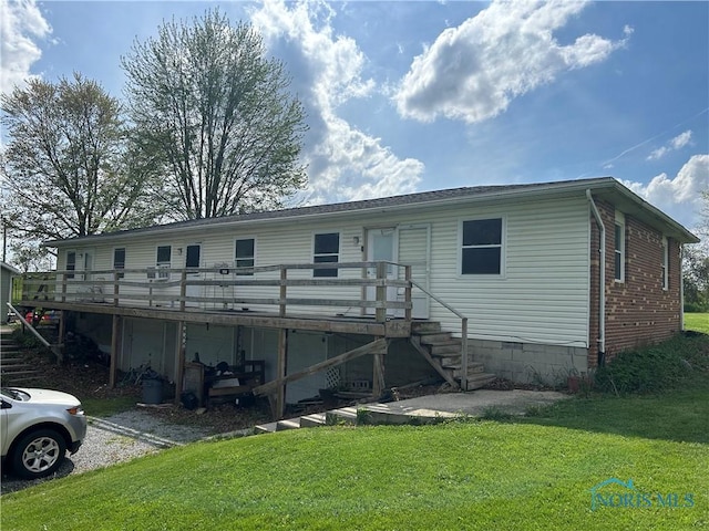 rear view of property with a yard, crawl space, a deck, and stairs
